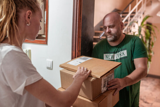 woman recieve delivery package from clothes online shop 