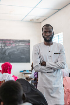 Confident School Teacher Standing in a Classroom in Senegal, Overseein