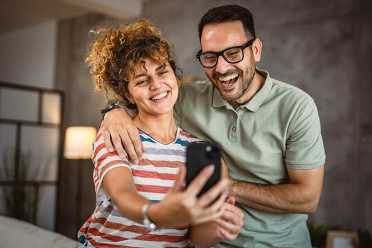 adult couple have a video call or take self portrait on mobile phone