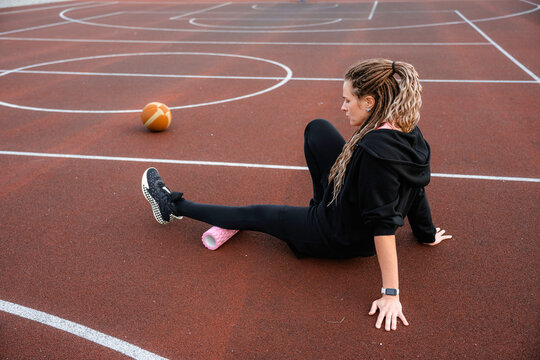 A woman does an exercise on a roller