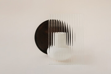 Half of dark tray visible from behind abstract glass