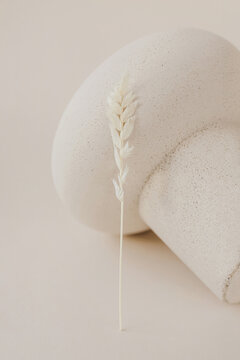 Artificial spikelet leaning on light patterned vase