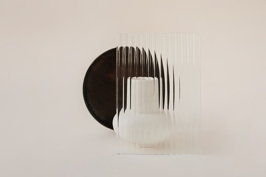 Half of dark tray visible from behind abstract glass