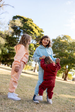 Kids playing in a parc with colourful tracksuit