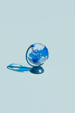 Vertical View of Minimalist Blue Globe on Light Blue Background