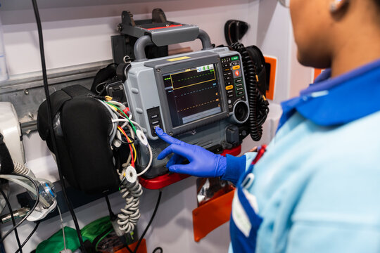 Paramedic monitoring vital signs in ambulance