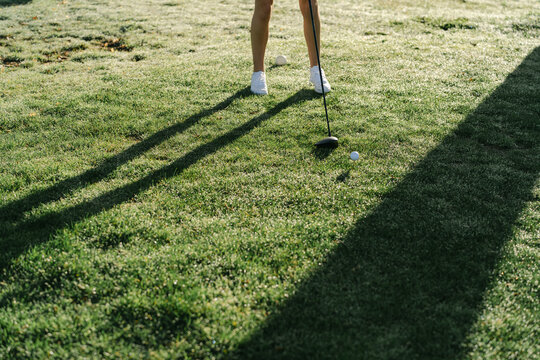  legs of young woman playing golf in the sun 