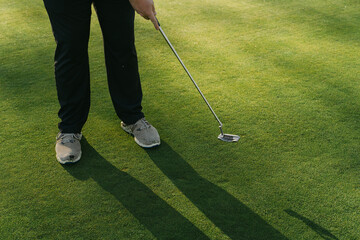Close up of legs of man playing golf 