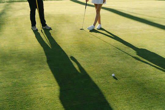 Close up of legs of young woman playing golf 