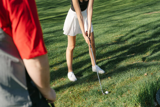  young couple  playing golf in the morning sun 