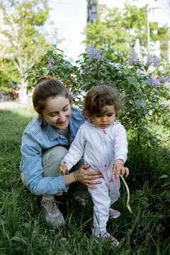 mother and ba by are walking in the park