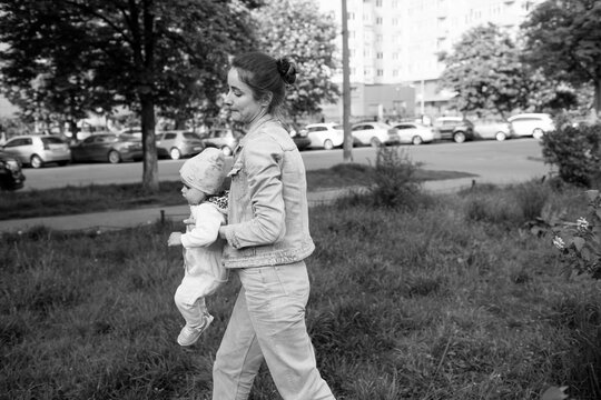 mother and ba by are walking in the park