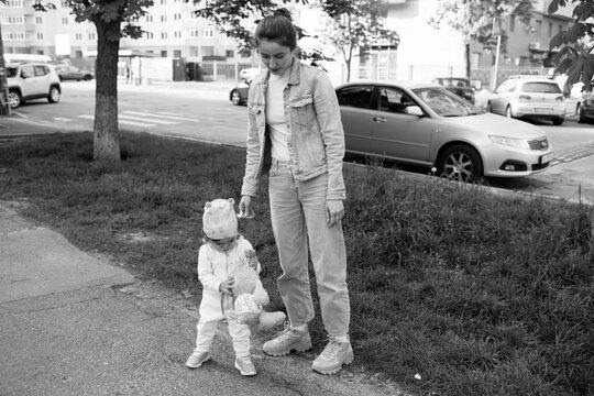 mother and ba by are walking in the park