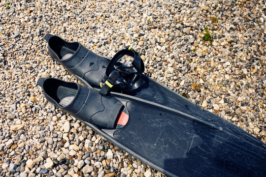 Diving fins on pebbles