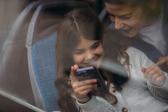 Mom and daughter riding train