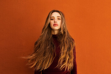 Stylish female model looking at camera in studio