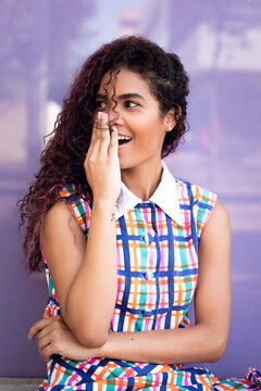 Young woman with hand at mouth