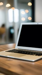 Fototapeta premium Sleek laptop on wooden table with white screen and black keyboard Vertical Mobile Wallpaper