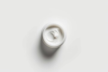 A single serving size of cream on a clean and simple background, ideal for food or cosmetic related compositions