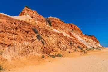 Fototapeta premium Colourful cliffs Algarve Portugal Falesia beach with red rocks and golden sand near Vilamoura and Albufeira