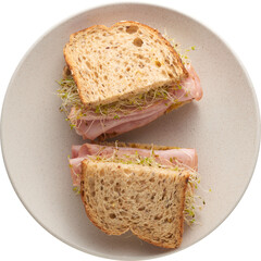 A homemade cut ham sandwich in a beige plate for lunch - Ready to use Premium PNG Cutout Isolated image, top view