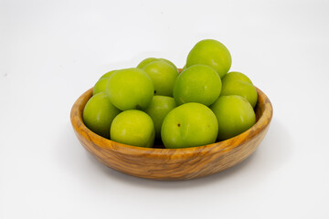 Bowl of Fresh Green Plums on White Background
