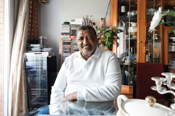 Retired black man sitting at home