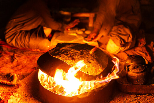 Bedouin people cooking bread at night