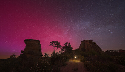 Aurora borealis / Northern lights and Milky Way over sky in Spain