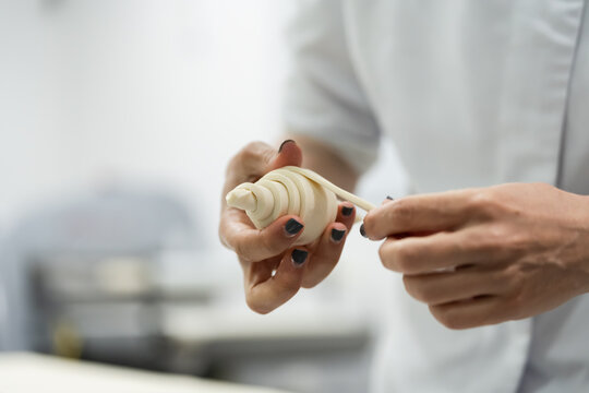 Artisan baker shaping dough by hand
