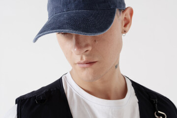 Stylish young man standing. Wearing casual clothes and baseball cap