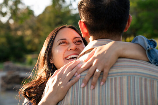 Loving young couple hug after proposal