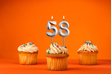 Candle number 58 - Celebration with birthday cupcake on orange background