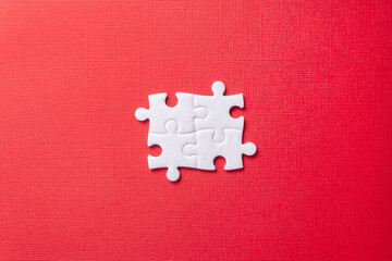 White elements from puzzle on red background. Concept of team work, business, community and professional occupation. Place for text