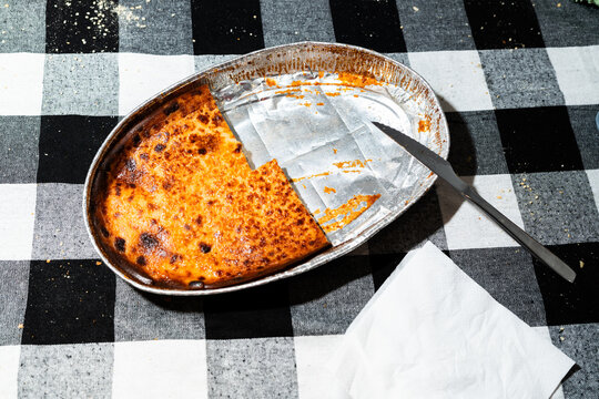 Half-Eaten Quesada Pasiega on Checkered Tablecloth During Daytime