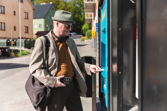 Middle age man in a teller machine