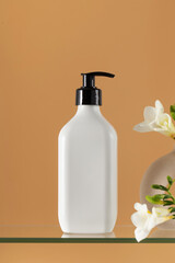 Blank plastic cosmetic product dispenser bottle and freesias