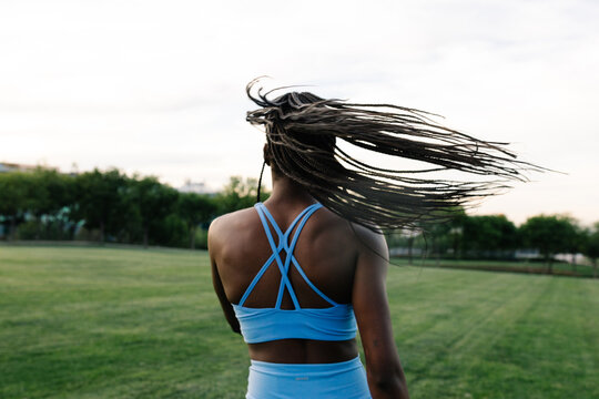 Afro female athlete walking backwards