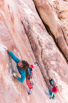 Fearless rock climber climbing a slab