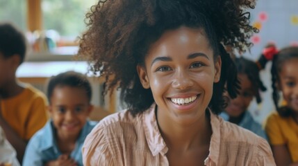 A happy teacher sits with her students in a school room, exuding warmth and positivity. The children are smiling and attentive, making the learning environment joyous.