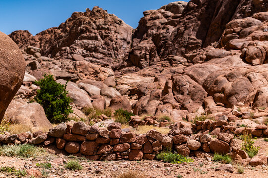 Stone wall fence in rocky desert landscape, arid environment