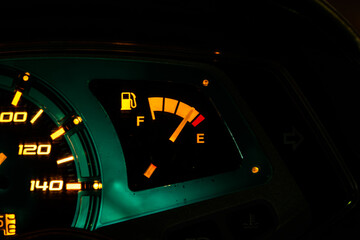 A car's fuel gauge is lit up in green