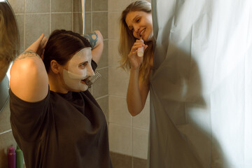 Woman with friend wearing face mask