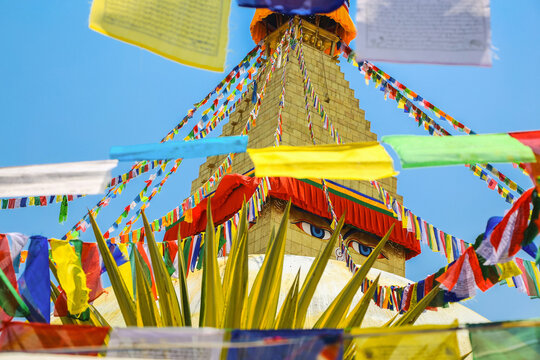 Boudhanath stupa with colorful prayer flags on a bright day