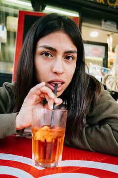 Young Woman Enjoying Drink in Caf&Atilde;&copy;