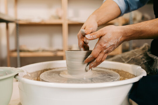 Close-up Hands Molding Clay on Spinning Wheel