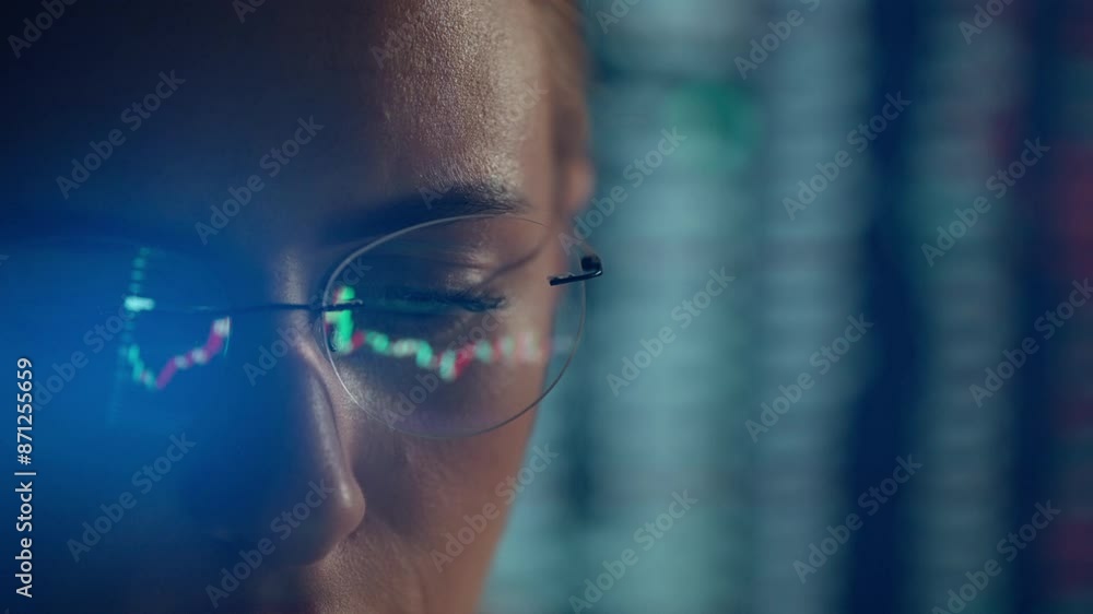 Poster trader wearing glasses is working on laptop computer. screen with stock market charts and bitcoin bt