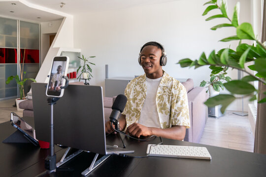 Podcaster Talking At Microphone In His Home