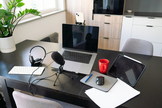 Computer, Microphone And Phone In Tripod On The Table
