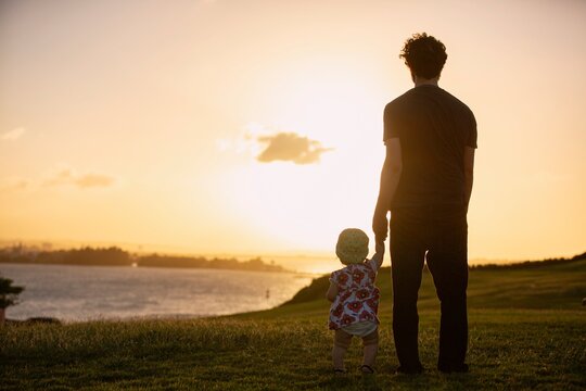 Father and Child Watching Sunset in San Juan